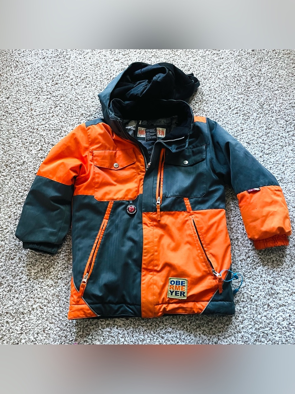 Obermeyer Kids Jacket in Orange and Black Accents